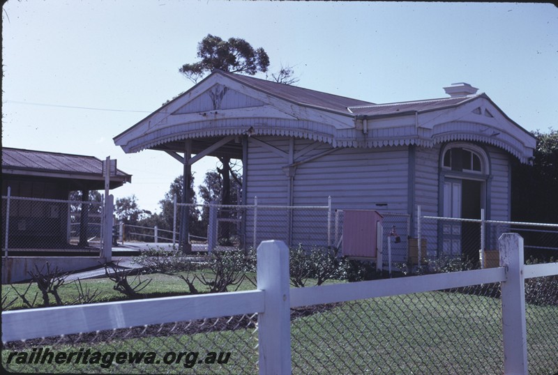 P14393
Station buildings, fire hose box, Karrakatta, view of the west end and streetside entrance of the main station building.
