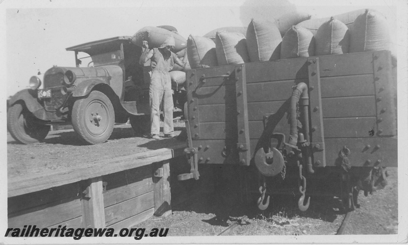 P14509
Bagged wheat being manually loaded onto a railway wagon, end view of wagon, Kumarl Siding, CE line
