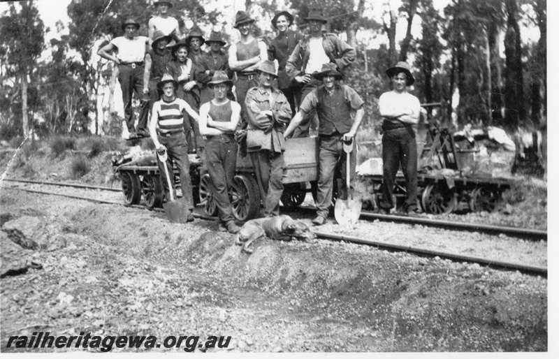 P14513
Workers posing on unpowered gangers trollies, pump trolley on the side of the track, location Unknown
