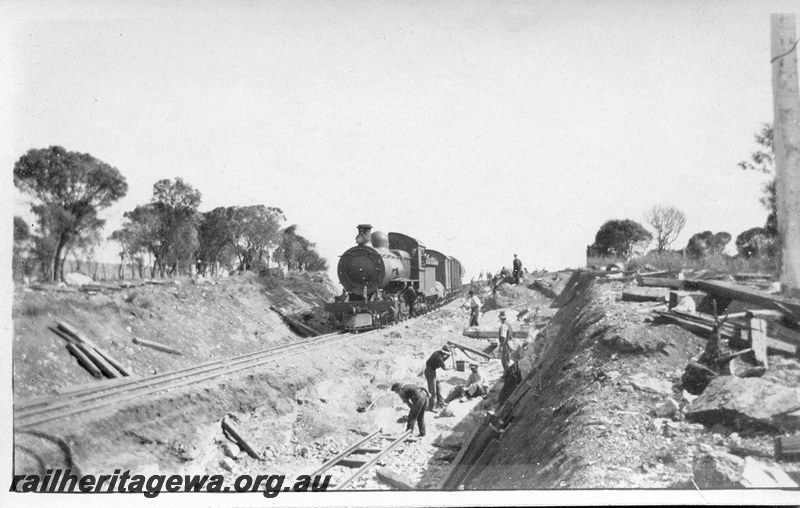 P14518
1 of 5 views of track construction possibly to lower the track through a cutting, F class on a goods train, workers in the lowered cutting
