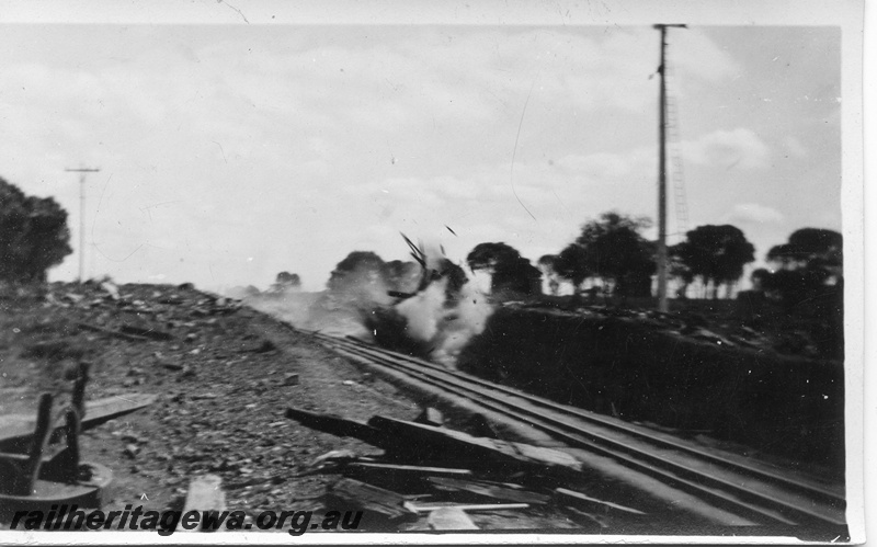 P14520
3 of 5 views of track construction possibly to lower the track through a cutting, explosion just taken place
