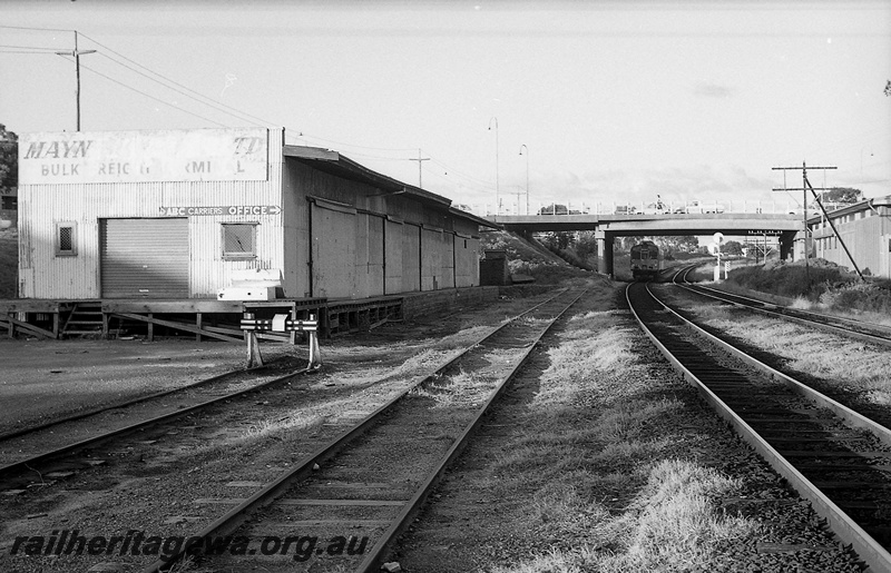 P14819
16 of 21 images of the railway precinct and station buildings at Subiaco, c1969, Mayne Nickless bulk freight shed, end and trackside view, railcar passing under the Axon Street over bridge, buffer stop
