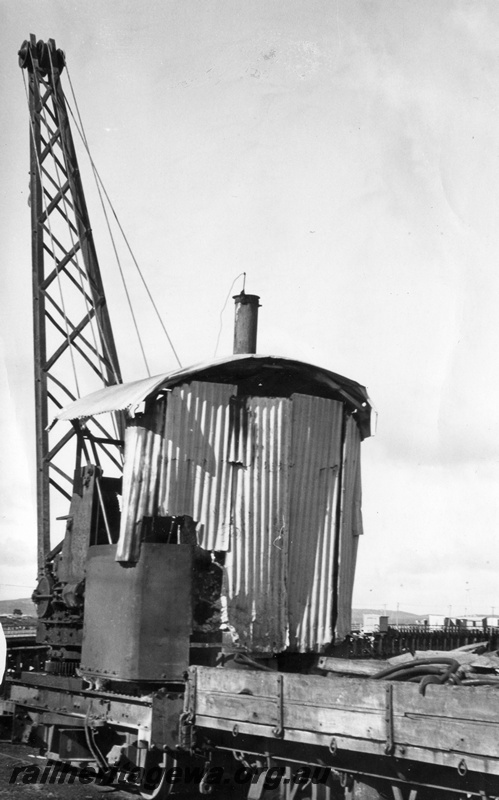 P15537
PWD steam crane No. 25, coupled to an ex H class low sided wagon, Albany wharf, side and end view, extensive use has been made of corrugated iron on the superstructure of the crane
