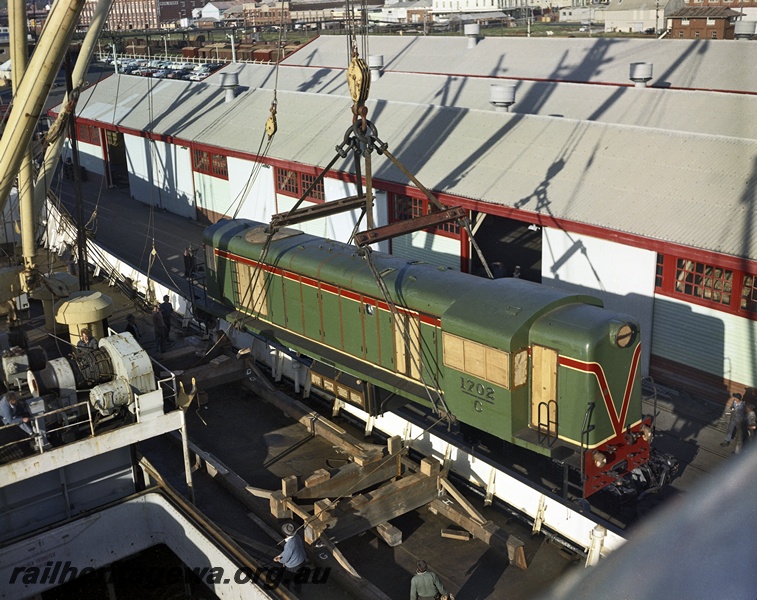 P15841
C class 1702 in the green with the red and yellow stripe livery being unloaded from the ship 