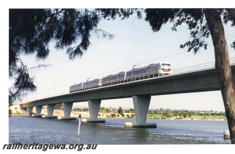 P16343
EMU two railcar set, crossing Swan River on concrete and steel Goongoongup bridge, East Perth, SWR line, side and front view
