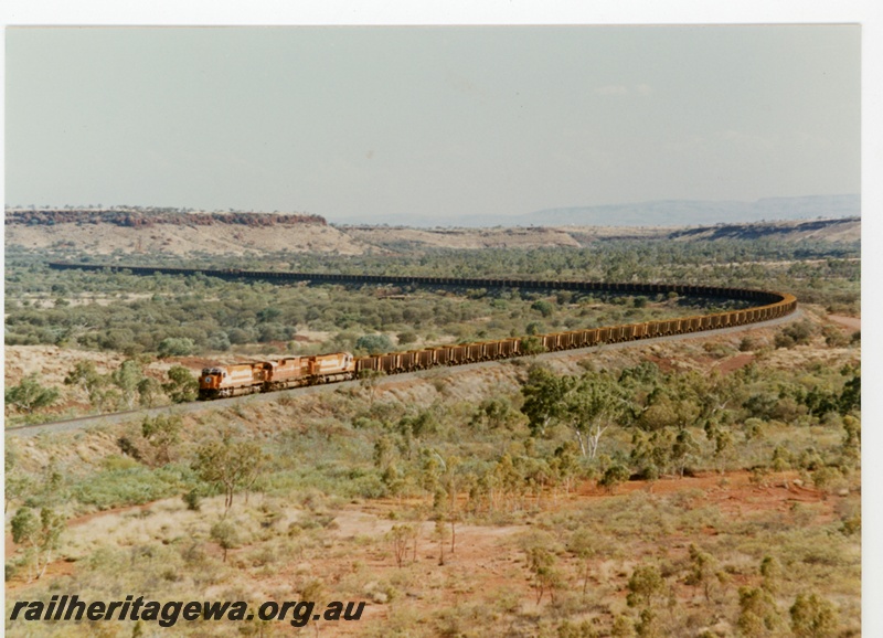 P16765
Mt Newman (MNM) triple headed ore train near Garden. Distant view.
