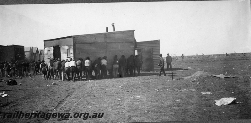 P16842
Commonwealth Railways (CR) - TAR line workers moving a building. Unknown location. C1916
