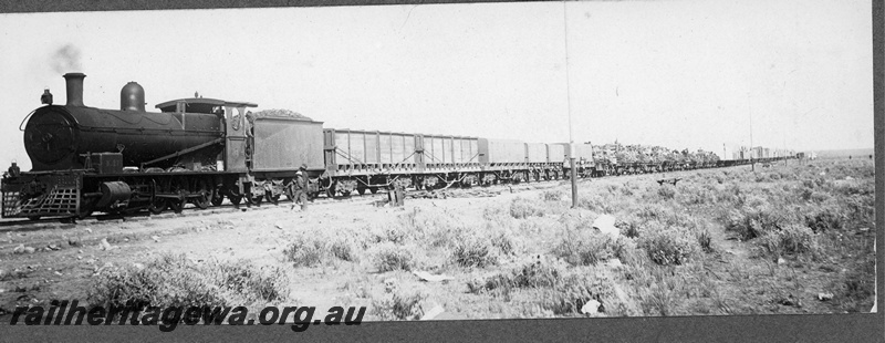 P16843
Commonwealth Railways (CR),G class steam locomotive hauls a supply train east across the Nullarbor, TAR line, Unknown location. C1916
