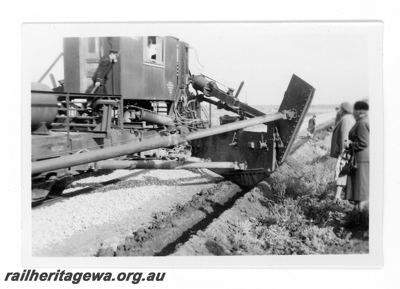 P16857
Commonwealth Railways (CR) - TAR line official inspection of track mounted machine used for digging drains alongside the track being propelled by an L class steam locomotive. 
