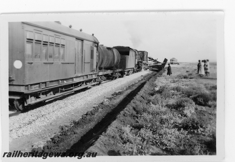 P16858
Commonwealth Railways (CR) - TAR line official inspection of track mounted machine used for digging drains alongside the track being propelled by an L class steam locomotive. Budd railcar in rear of photo. 
