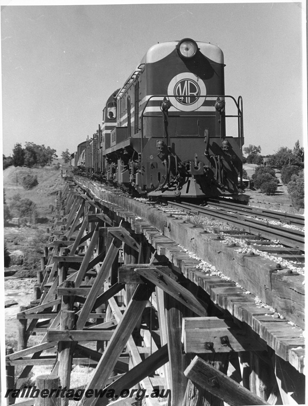 P16897
MRWA G class 50 diesel locomotive hauling a freight train over the Swan River at Upper Swan. MR line. C1960s
