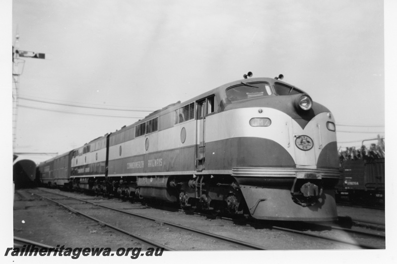 P16990
Commonwealth Railways (CR) GM1 class 7, coupled back to back with another GM1 class loco, on passenger train, signal, Kalgoorlie, TAR line, side and front view, c1958
