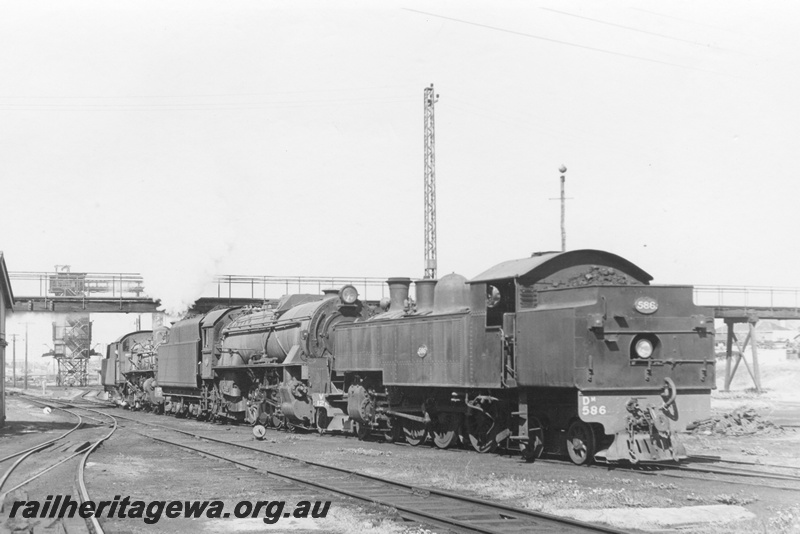P17086
DM class 586,V class 1211 and PMR class 738 steam locomotives at East Perth locomotive depot. Coal Stage in the background and Summer St footbridge. Works building to left of locomotives and power line rising above. ER line. 
