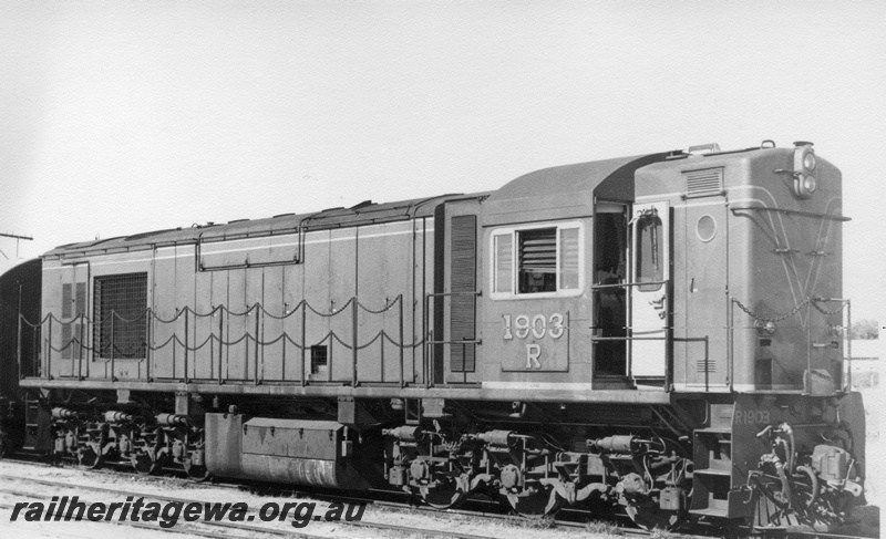 P17143
R class 1903 diesel electric locomotive at an unidentified location. Good side view and partial front view of locomotive.
