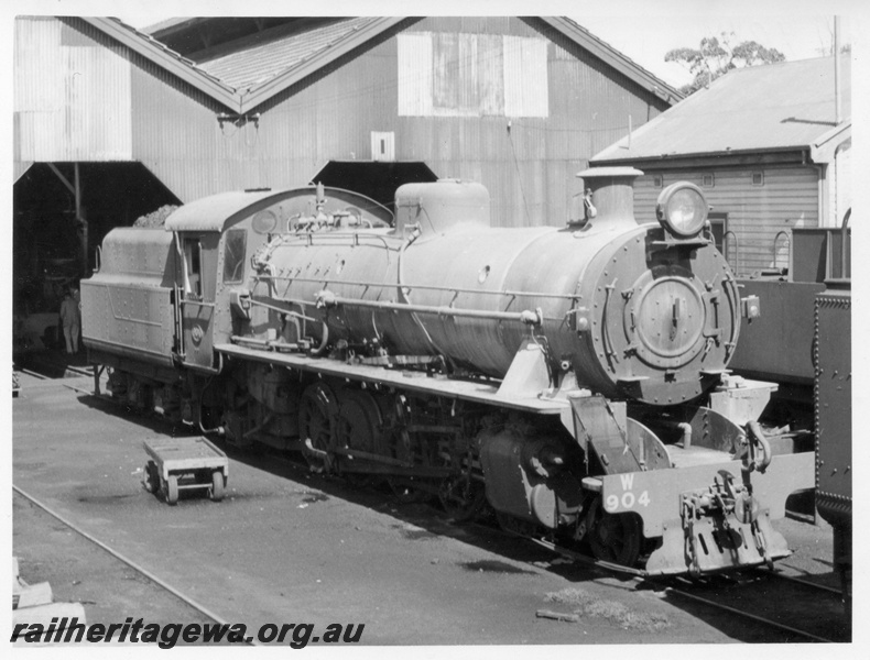 P17153
W class 904 locomotive at East Perth loco. Note spark arrestor screen on right front buffer beam of loco. Loco buildings to right and rear of locomotive.
