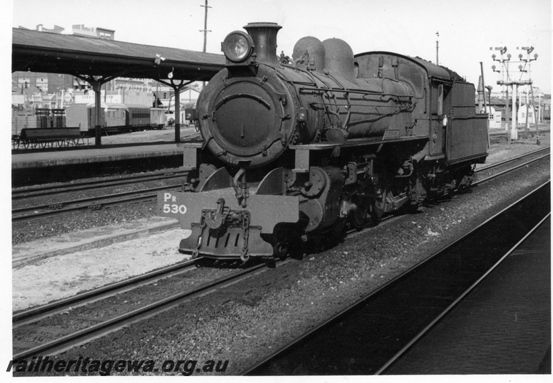 P17154
PR class 530 locomotive at western end of Perth Station. Note semaphore signals in background and portion of Perth Goods yard at left of locomotive.
