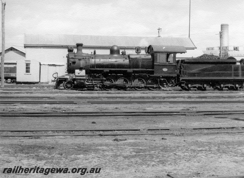 P17155
F class 412 locomotive at East Perth loco. Overhead fuel tank showing over loco tender and loco buildings next to loco.
