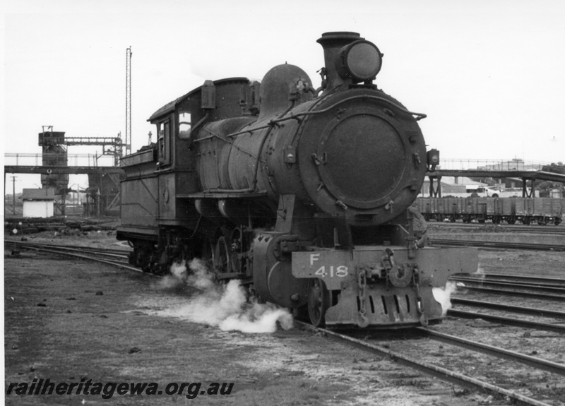 P17156
F class 418 locomotive at East Perth loco. Note coal stage and footbridge in background and wagons to right of loco.
