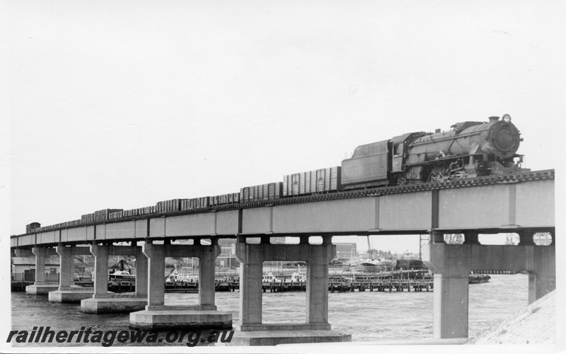 P17172
2 of 3, V class 1220 steam locomotive, side and front view, on the number 56 goods train, crossing the Fremantle railway bridge.
