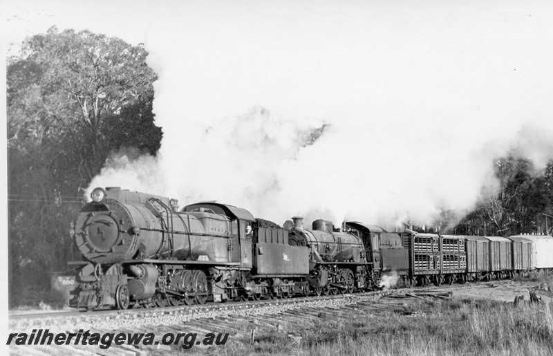 P17447
S class 550 and W class 940 steam locomotives hauling 335 goods between Donnybrook and Brookhampton on the PP line. Side views of both locomotives and of the leading freight vehicles. 
