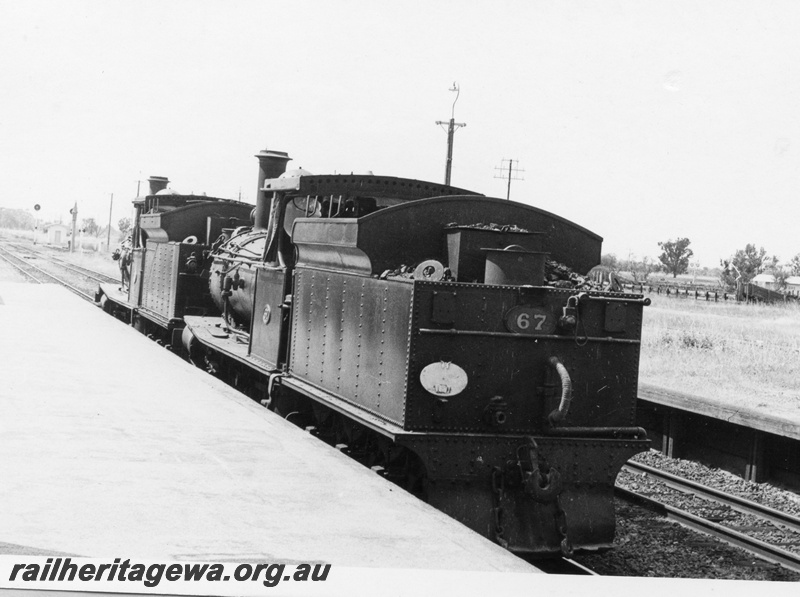 P17455
G class 118 & G class 67 steam locomotives at Pinjarra, enroute to Midland Workshops. SWR line. 
