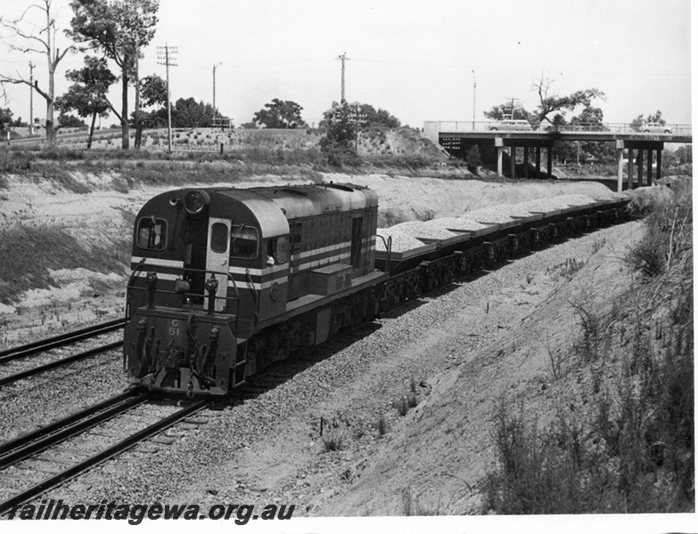 P17599
G class 51 diesel locomotive, with loaded ballast wagons in lead of other goods vehicles eastbound under the Great Eastern Highway overbridge at Bellevue. ER line. 

