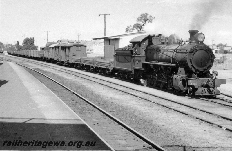 P17644
F class 462 steam locomotive shunting at Bassendean. ER line. Unidentified bogie van behind low sided open wagons. Note portion of goods shed at rear right.
