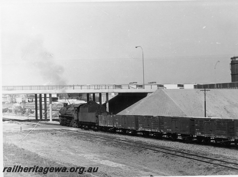 P17770
PMR class 732 steam locomotive departing East Perth on 35 Goods and approaching near new Plain Street overbridge.Railway Road Service road coach depot visible under bridge and to right of train. Portion of former East Pert Gasometer visible on right edge of photo.
