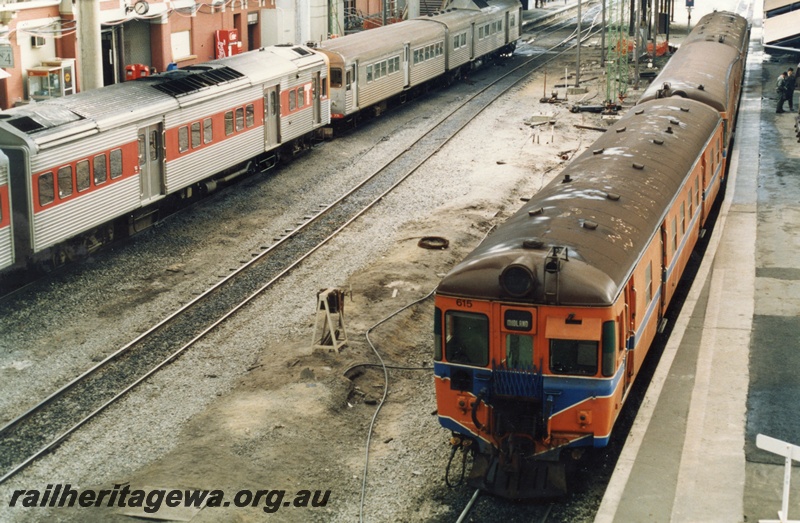 P18068
11 of 11 Construction of new Perth City station, DMU to Midland headed by ADG/V class 615, standing at platform, two DMUs standing at platform 4, one orange and stainless steel, the other stainless steel, light signal, Perth City station
