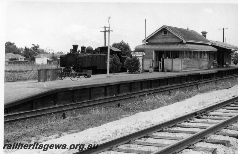 P18237
Suburban tank loco, standard gauge track in foreground, platform, bicycle in rack, light, trolley, signal box, station building, Bellevue, ER line, c1966

