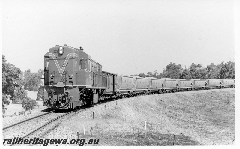 P18242
R class 1904, on bauxite train, in rural setting, front and side view
