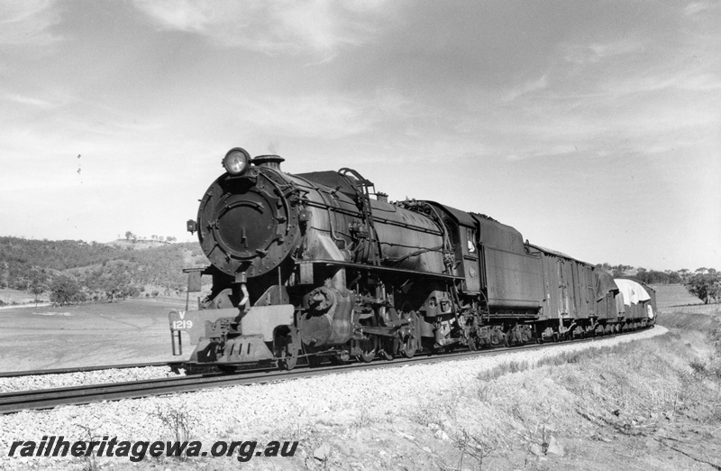 P18251
V class 1219, on goods train, in rural setting, front and side view, c1968
