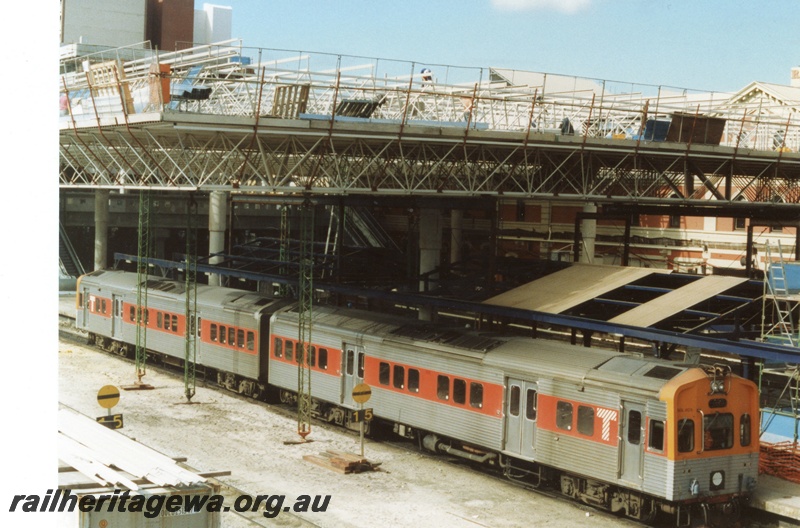 P18313
DMU two car set comprising ADL class 805 and ADC class 855 class railcar trailer, Perth city station under reconstruction, old station building partly obscured by scaffolding and new roof 
