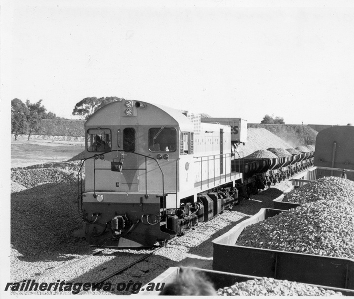 P18388
3 of 5 images of J class 101 on standard gauge ballast train comprising ex-Commonwealth Railways (CR) WSJ class hoppers near Kenwick, end and side view of loco and train on ballast working, another rake of hoppers on adjacent track
