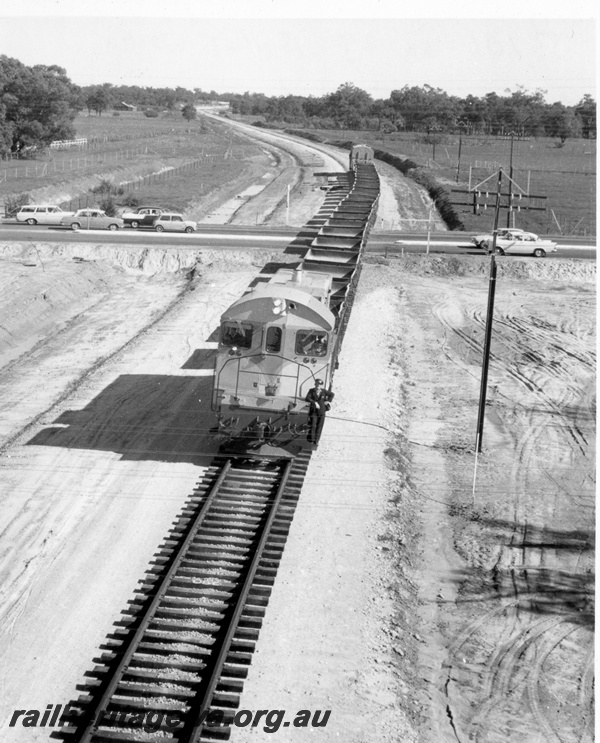 P18390
5 of 5 images of J class 101 on standard gauge ballast train comprising ex-Commonwealth Railways (CR) WSJ class hoppers near Kenwick, crossing Albany Highway, Kenwick
