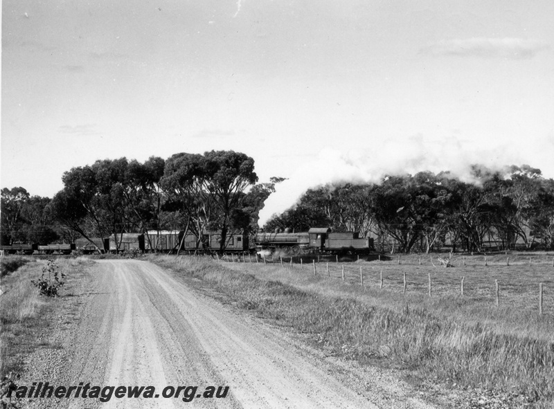P18441
P class 508, banking on Narrogin to York goods train hauled by V class 1204 out of shot, dirt road in foreground, GSR line. See P18440, P18442
