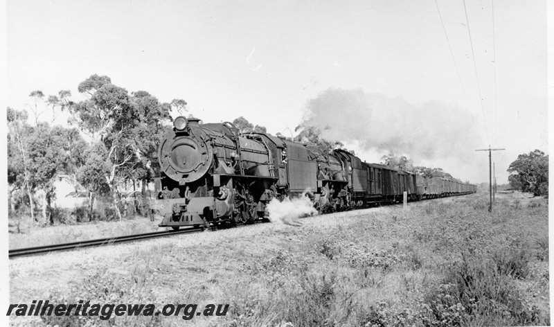 P18526
V class 1210 and V class 1216, on combined No 11 and No 3 goods train, rural setting, front and side view

