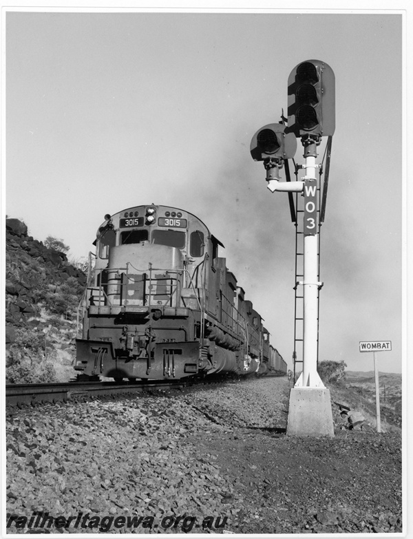 P18814
Hamersley Iron (HI) M636 class 3015 leads an loaded iron ore train through Wombat. 

