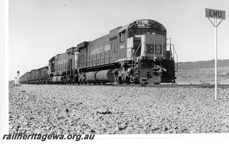 P18832
Hamersley iron (HI) M636 4045 leads a loaded iron ore train through Emu.
