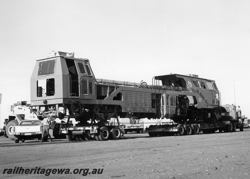 P18863
Mount Newman (MNM) Mecnafer SPA rail tamper on low loader at Newman.
