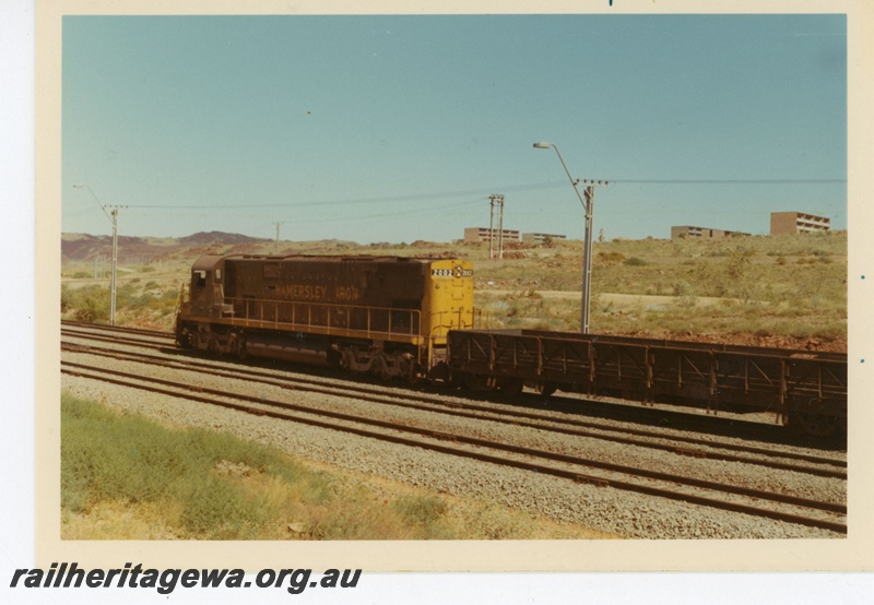 P18884
Hamersley iron (HI) C628 class 2002 at Parker Point, Dampier. Drop sided flat car attached to locomotive.
