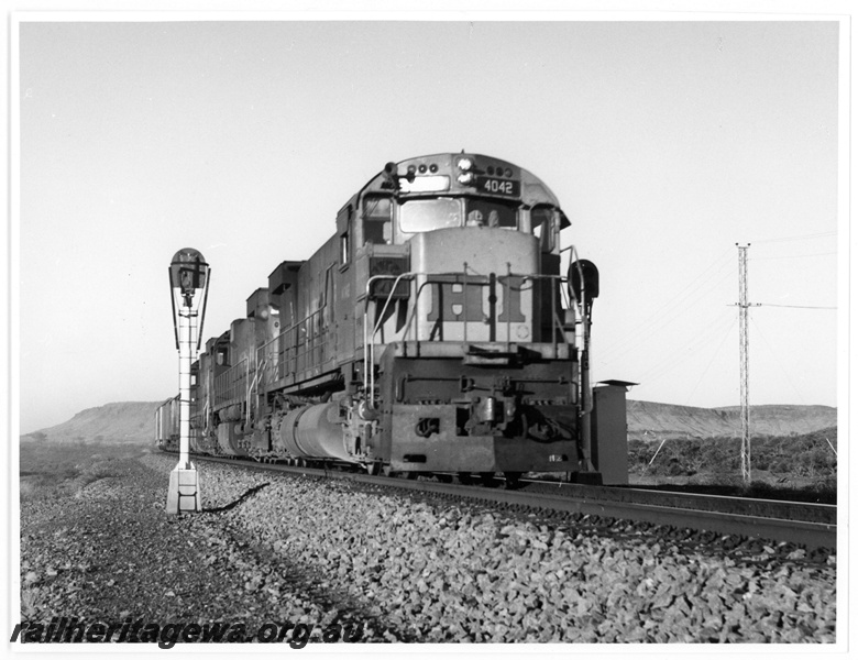 P18912
Hamersley Iron (HI) M636 class 4042 leads a loaded iron ore train near Wombat.
