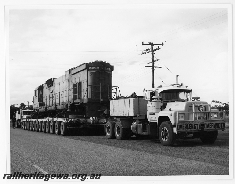P18913
Mount Newman (MNM) C636 class 5459 being transported on a low loader for rebuilding by Goninan WA. Photo taken on Great Northern Hwy New Norcia. 
