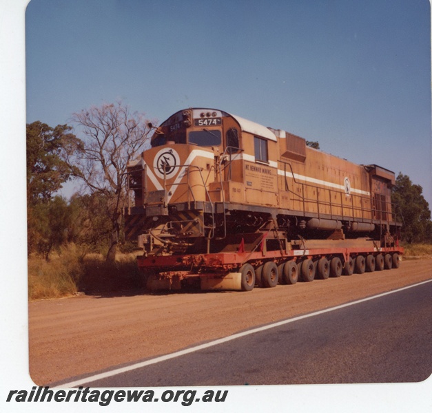 P18928
Mount Newman (MNM) M636 class 5474 on low loader Great Northern Hwy near Pearce. The loco was enroute to Comeng Bassendean for rebuilding. 
