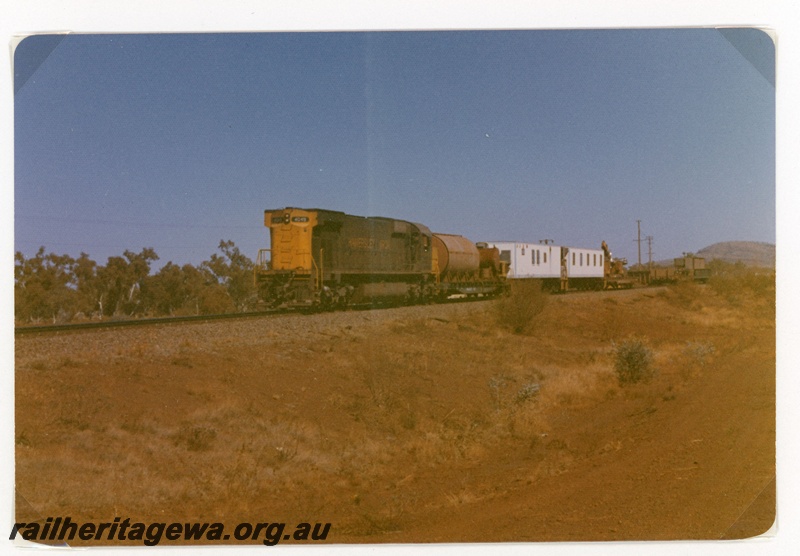 P18955
Hamersley Iron (HI) M636 class 4049 hauls camp train near the site of a derailment at Possum.
