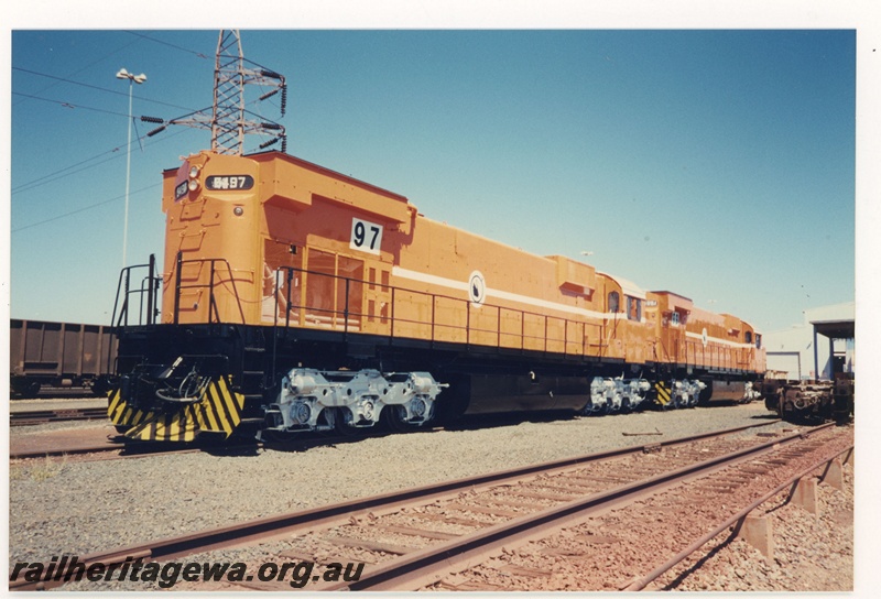 P18976
Mount Newman Mining (MNM) M636 class 5479, orange livery, Nelson Point, Port Hedland, end and side view.
