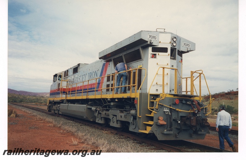 P18980
Hamersley Iron (HI) C44-9W class 7070 locomotive in the silver livery with red and blue striping, side and end view
