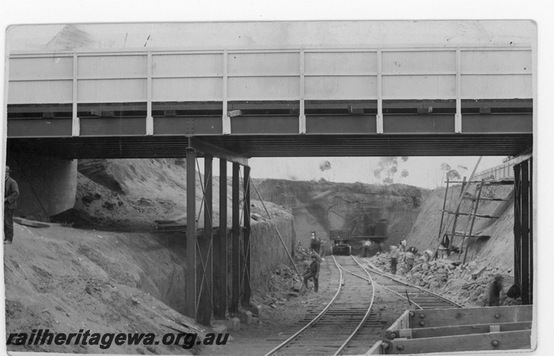 P19012
Commonwealth Railways (CR) cutting excavation in progress, track, workers, wagons, overpass, near where first sod turned on TAR, Port Augusta, South Australia, TAR line, c1912
