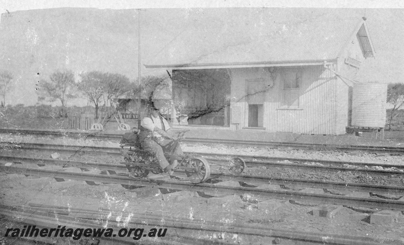 P19017
Trike trolley, ridden by Thomas French, tracks, point levers, station building, Wirraminna, South Australia, TAR line

