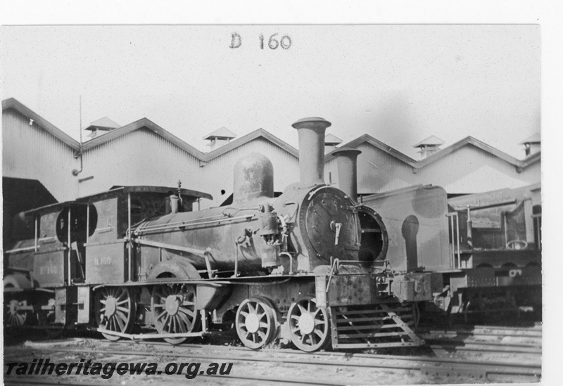 P19158
Commonwealth Railways (CR) D class 160 in the foreground with D class163 behind, outside sheds, Port Augusta, TAR line, track level view
